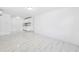 Bright kitchen featuring white cabinets, granite countertops, and modern flooring at 6010 Blossom Ave, Tampa, FL 33614