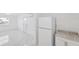 Open room featuring tile flooring, neutral colors, a kitchen and entry at 6010 Blossom Ave, Tampa, FL 33614
