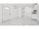 Open floor plan living space with tile flooring, neutral colors and lots of light at 6010 Blossom Ave, Tampa, FL 33614