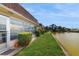 Backyard overlooking a peaceful pond, complete with well-maintained grass and neatly trimmed hedges at 623 Park Cir # 623, Bradenton, FL 34207