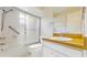 This full bathroom features tiled shower-tub combination, window, white vanity, and tile flooring at 623 Park Cir # 623, Bradenton, FL 34207