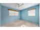 This bedroom offers natural light from two windows, carpet flooring, and a ceiling fan at 623 Park Cir # 623, Bradenton, FL 34207