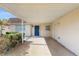 Covered carport offering convenient parking and storage near the bright blue front door at 623 Park Cir # 623, Bradenton, FL 34207
