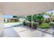 Spacious carport offering a covered parking area and view of the beautifully landscaped property at 623 Park Cir # 623, Bradenton, FL 34207