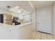 Kitchen features stainless steel appliances, a breakfast bar, and a white front door with tile flooring at 623 Park Cir # 623, Bradenton, FL 34207