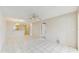 Open living room area with a tile floor, ceiling fan, and access to the kitchen and other rooms at 623 Park Cir # 623, Bradenton, FL 34207