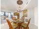 Charming dining room featuring stylish lighting and seamless access to the living room and kitchen at 690 Island Way # 1011, Clearwater Beach, FL 33767