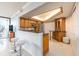 Bright kitchen featuring bar seating, stainless steel appliances, and wood cabinetry at 690 Island Way # 1011, Clearwater Beach, FL 33767