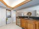 Modern kitchen with a breakfast bar, stainless steel appliances, and natural light at 690 Island Way # 1011, Clearwater Beach, FL 33767