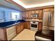 Modern kitchen with stainless steel appliances, granite countertops, and ample cabinet space at 690 Island Way # 1011, Clearwater Beach, FL 33767