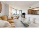 Bright living room with balcony access, an adjacent kitchen, and tile flooring throughout at 690 Island Way # 1011, Clearwater Beach, FL 33767
