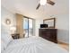 Main bedroom with furniture, ceiling fan and large sliding glass doors to balcony at 690 Island Way # 1011, Clearwater Beach, FL 33767