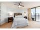 Comfortable main bedroom with a ceiling fan and access to the balcony at 690 Island Way # 1011, Clearwater Beach, FL 33767