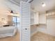 Walk-in closet with built in shelving located adjacent to the main bedroom at 690 Island Way # 1011, Clearwater Beach, FL 33767