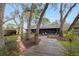Backyard featuring a screened porch area and a wooden walkway at 7247 Oelsner St, New Port Richey, FL 34652