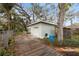 Detached garage with a roll-up door and ample storage space at 7247 Oelsner St, New Port Richey, FL 34652