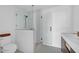 Modern bathroom features a sleek glass shower, contemporary fixtures, and white tile, creating a spa-like experience at 8262 26Th N Ave, St Petersburg, FL 33710