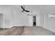 Spacious bedroom boasts a barn door leading to en-suite bath and a modern ceiling fan, offering style and comfort at 8262 26Th N Ave, St Petersburg, FL 33710