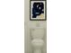 Clean white toilet beneath a modern artwork and decorative candle for a functional and appealing bathroom at 8920 Gulf Shore Ter, Parrish, FL 34219