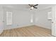 Comfortable bedroom with two windows and a ceiling fan at 9155 125Th St, Seminole, FL 33772