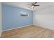 Cozy bedroom with a ceiling fan and a bright blue accent wall at 9155 125Th St, Seminole, FL 33772