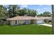 Charming single-story home with a well-manicured lawn and attached two-car garage at 9155 125Th St, Seminole, FL 33772