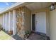 Close-up of front door with stone accent wall and modern lighting at 9155 125Th St, Seminole, FL 33772