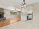 Open-concept living space featuring hardwood floors, stone fireplace, and white cabinets at 9155 125Th St, Seminole, FL 33772