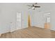 Main bedroom has wood floors, ceiling fan, a closet, and ensuite bathroom access at 9155 125Th St, Seminole, FL 33772