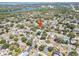 Aerial view showcasing the home's location within a lush, established neighborhood near a lake and cityscape at 920 16Th Sw Ave, Largo, FL 33770