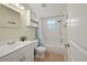 This bathroom features tile flooring, a shower/tub combo, a vanity, and bright lighting at 920 16Th Sw Ave, Largo, FL 33770