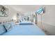 This bedroom has 2 beds and a tv, along with a sliding glass door leading outside at 920 16Th Sw Ave, Largo, FL 33770