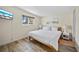 Light and bright bedroom featuring a comfortable queen bed, wood floors, and beach-themed artwork at 920 16Th Sw Ave, Largo, FL 33770