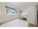 This bedroom is well-lit with neutral colors, a mounted television, and a window at 920 16Th Sw Ave, Largo, FL 33770