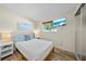 Cozy bedroom featuring a comfortable bed, mounted television and light, airy decor at 920 16Th Sw Ave, Largo, FL 33770