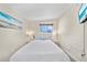 Cozy bedroom featuring a comfortable queen bed, matching nightstands, and a bright window with a view at 920 16Th Sw Ave, Largo, FL 33770