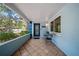 Inviting front porch featuring a stylish door, tiled flooring, and a cozy seating area at 920 16Th Sw Ave, Largo, FL 33770