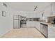 Well-lit kitchen with stainless steel appliances, white cabinetry, and a functional layout for easy meal preparation at 920 16Th Sw Ave, Largo, FL 33770