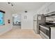 Functional kitchen with stainless steel appliances and ample space, with a view into the dining area at 920 16Th Sw Ave, Largo, FL 33770