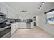 Modern kitchen featuring white cabinets, granite countertops, and stainless steel appliances with an open view at 920 16Th Sw Ave, Largo, FL 33770