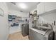 Well-organized laundry room with modern washer and dryer, ample shelving, and convenient storage cabinets at 920 16Th Sw Ave, Largo, FL 33770