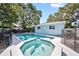 Inviting pool and spa with a safety fence, surrounded by manicured landscaping, ideal for relaxation and recreation at 920 16Th Sw Ave, Largo, FL 33770