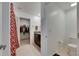 Bathroom featuring granite countertops, a toilet, and an adjacent walk-in closet at 9907 Spanish Lime Ct, Riverview, FL 33578