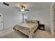 Cozy bedroom featuring a floral bedspread, ceiling fan, and a nightstand with cute decor at 9907 Spanish Lime Ct, Riverview, FL 33578