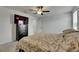 Bright bedroom with a ceiling fan, television and an open doorway to another room at 9907 Spanish Lime Ct, Riverview, FL 33578