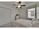 Bedroom features a ceiling fan, closet, window with blinds and carpeted flooring at 9907 Spanish Lime Ct, Riverview, FL 33578