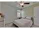 Bedroom with pale green accent wall, ceiling fan, and a bright window at 9907 Spanish Lime Ct, Riverview, FL 33578