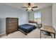 Bedroom featuring a ceiling fan, a window with blinds, and dark wood furniture at 9907 Spanish Lime Ct, Riverview, FL 33578