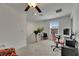Bright bedroom with window, ceiling fan and a pink gaming chair and wall decor at 9907 Spanish Lime Ct, Riverview, FL 33578