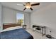 Bedroom featuring a ceiling fan, a window with blinds, and a desk at 9907 Spanish Lime Ct, Riverview, FL 33578